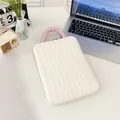 Quilted beige laptop sleeve with purple ruched handle on a minimalist white desk - Vertical White