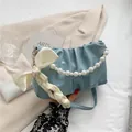 Light blue ruched cloud bag featuring pearl handle and white silk bow detail - With Pearl Chain Handle / Blue