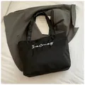 Minimalist black tote bag with I am Creamy print for daily office or school use - Black