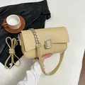 Light khaki pebbled leather shoulder bag with silver chain and metal buckle detail - Yellow