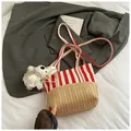 Straw and canvas bucket bag with red and white stripes and a plush doll pendant - With Charm / Red