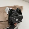 Schwarzer gesteppter Lederrucksack mit Rautenmuster und silberner Metallkette - Schwarz