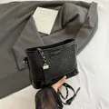 Borsa a secchiello nera intrecciata con tracolla a catena e nappa decorativa - Nero