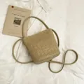Borsa a secchiello in paglia intrecciata kaki con tracolla in pelle e logo - Cachi