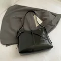 Fashionable black glossy hobo bag with silver ring and drawstring details - Black Without Charm