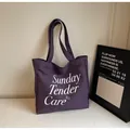 Dettaglio della borsa tote in tela viola scuro con scritta bianca Sunday Tender Care - Viola