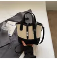Borsa a secchiello bicolore panna e nera in pelle martellata con chiusura a rotazione - Patchwork Nero e Bianco