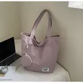 Detail of purple fabric tote bag with outer pocket and matching small coin purse - Purple