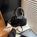 Stylish black crinkled patent leather bowling bag featuring top handles and strap - No Pendant / Black