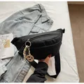 Detail of black canvas chest bag with zipper, woven rope charm and adjustable strap - With Ornament / Black