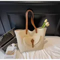 Dettaglio della borsa tote in paglia intrecciata con tracolla in similpelle marrone e tasca - Bianco Sporco