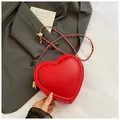 Mini red heart-shaped leather crossbody bag with gold chain and woven leather strap - Red