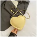 Creamy yellow heart-shaped crossbody bag with gold chain and adjustable bead detail - Yellow
