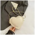 Fashionable cream heart-shaped crossbody bag with adjustable gold chain strap - White