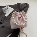 Pink drawstring bucket bag in floral satin with large pearl handle and gold chain strap - Pink Butterfly