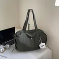 Waterproof nylon tote bag in dark green featuring a plush monster charm and large capacity - Dark Green No Charm