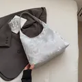 Silver shoulder hobo bag featuring lilac butterfly patterns and metallic texture finish - Silver Butterfly
