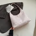 Light pink butterfly jacquard hobo bag with silky texture on grey blazer backdrop - Pink Butterfly