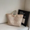 Beige geweven strooien draagtas met TOTEBAG borduursel en kunstleren handgrepen - Off-wit