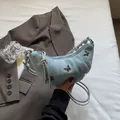 Borsa a mezzaluna in denim azzurro con farfalle metalliche e tracolla a corda argento - Celeste
