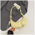 Chic cream-colored hobo bag with knotted double straps and star pendant on a grey blazer - Star Pendant Included / Yellow
