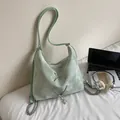 Mint green textured tote bag with pearl butterfly charm and stylish metal lacing - Green