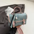 Blue denim and pink leather crossbody bag with star pendant and tassel accents - Pink With Pendant