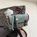 Light blue canvas retro messenger bag with brown leather trim and stylish charms - Coffee With Pendant