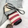Mini bucket bag in red and white stripes with black leather trim and adjustable strap - Red