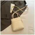 Chic cream white mini bucket bag with cross-body strap and front pocket detail - Rice White (No Pendant)