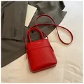Chic red mini bucket handbag in smooth leather with gold text and crossbody strap - Red (No Pendant)