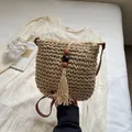 Handmade woven straw crossbody bag with wooden bead tassel and leather strap in beige - Off White