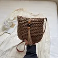 Handcrafted dark brown woven crossbody bag with bohemian wood bead and rope tassel detail - Khaki