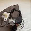 Dark grey woven half-moon shell bag with pearl bow and black pleated handle - Black With Pendant