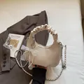 Creamy beige shell handbag with pleated handle, chain strap and pearl bow charm - Off-white With Pendant
