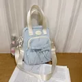 Light blue fabric crossbody bag with bow tie front pocket and adjustable strap - No Pendant / Blue