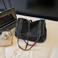 Chic black washed denim crossbody bag with dual shoulder straps and metallic buckle detail - Black