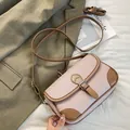 Pink lychee grain leather square crossbody bag with brown trim and buckle closure - Pink