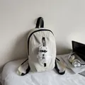 Creamy white nylon backpack with cute plush puppy charm for stylish street leisure use - With Charm / Off White