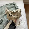 Minimalist beige nylon crossbody bag with black brand lettering and adjustable strap - Off White