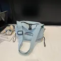 Light blue nylon dumpling bag with adjustable shoulder strap and BANATU brand logo - Blue