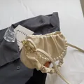 Chic cream ruched cloud bag with white pearl handle and golden hardware details - Off White