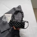 Polka dot cylindrical handbag in black patent leather with crossbody strap - Black