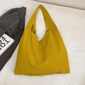 Minimalist canvas tote bag in vibrant mustard yellow with spacious nylon fabric design - Yellow