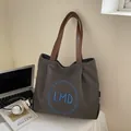 Dunkelgraue Canvas-Einkaufstasche mit braunen Ledergriffen und blauem LMD-Stickerei-Logo - Dunkelbraun
