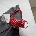 Red patent leather cylinder bag with white polka dots and detachable shoulder strap - Red