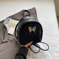 Mini zainetto nero da donna con pois glitterati argento e chiusura a farfalla metallica - Nero