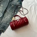 Quilted red cylinder crossbody bag with chain strap and lace bow accent in detail - Red