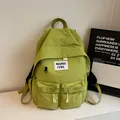 Minimalist grass green nylon backpack with multiple utility pockets and woven label - No Pendant / Green