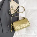 Metallic gold woven cylinder crossbody bag with knotted strap for summer fashion - Gold